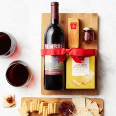 wine, cheese and crackers on a cutting board