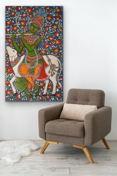 a chair sitting in front of a painting on the wall