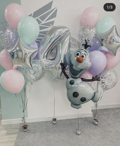 balloons and heliums are arranged in the shape of characters from frozen world, including person