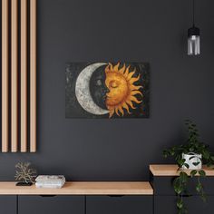 the sun and moon are hanging on the wall in this living room with black walls