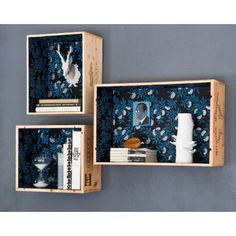 two wooden boxes with books and pictures on them