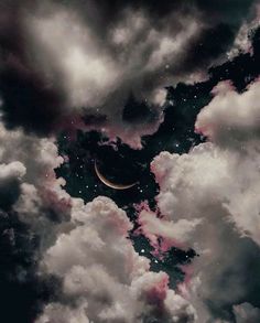 the moon is in the cloudy sky with clouds around it and some dark blue, pink and white colors