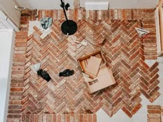 an overhead view of a brick floor with various items on the floor and around it