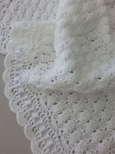 two crocheted doily on top of each other with one white object in the middle