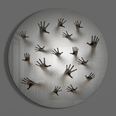 many hands are arranged in the shape of a circle on a white background with black shadow