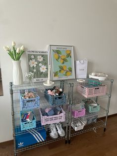 there is a shelf with baskets and pictures on it