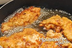 some fried chicken is cooking in a frying pan