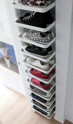 a white shoe rack filled with lots of shoes