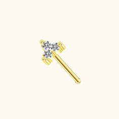 a gold nose pin with two diamonds on the top and one diamond in the middle