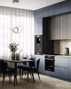 a modern kitchen with blue chairs and wooden table