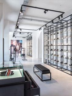 a shoe store with glass shelves filled with shoes