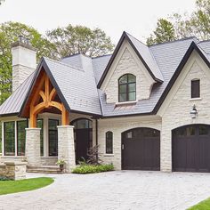 a large brick house with two garages on the front and one story above it