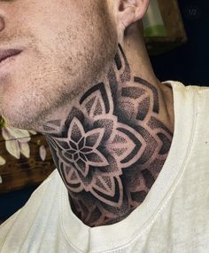 a man with a neck tattoo that has a flower on it