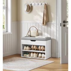 a white shoe rack with shoes and purses on it in front of a door