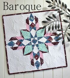 a close up of a quilt on a wall with the words barqque above it