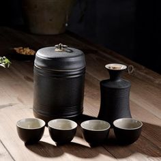 black containers and bowls on a wooden table