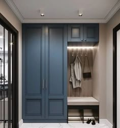 a large closet with blue cabinets and white marble counter tops in a home entryway