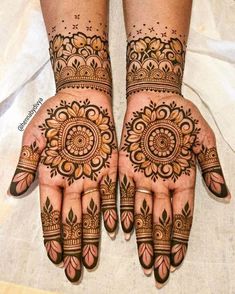 two hands with henna designs on them