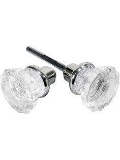 two clear glass knobs with a screw in the middle