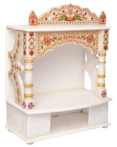 a white and gold decorated wooden shrine