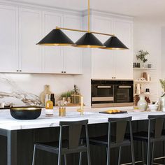 a kitchen with black chairs and white counter tops