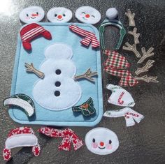 some felt snowmen and hats on a table