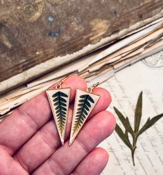 Beautiful and simple fern earrings on gold triangles. Dark green fern leaves on natural color, off white backgrounds, set with resin inside gold triangles.  These fern earrings are just over 2" long from the tops of gold tone earring hooks. Dried Greenery, Green And Gold Earrings, Fern Earrings, Earrings Triangle, Fern Leaves, White Backgrounds, Fern Leaf, Botanical Jewelry, Triangle Earrings