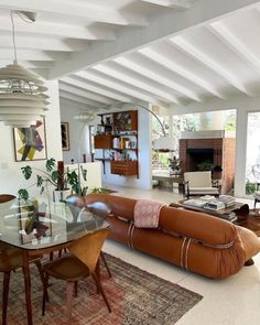 a living room filled with furniture and a fire place in the middle of a room