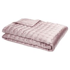 a pink comforter set on top of a bed