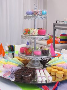 there is a cake and cupcakes on the table with other items around it