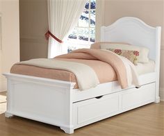 a white bed with two drawers underneath it