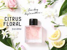 a bottle of perfume surrounded by flowers and lemons on a white background with the words citrus floral