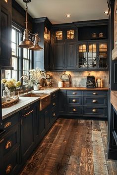 a kitchen with wooden floors and black cabinets