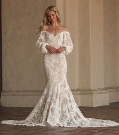 Introducing the Aspen Dress—your one-of-a-kind wedding gown brought to life. This off-the-shoulder wedding dress with sleeves is designed to make you feel like the most unique and beautiful bride. Crafted from luxurious textured cord cotton lace, it combines comfort with elegance. The off-the-shoulder neckline and dipped lower back create a stunning silhouette, while the voluminous puffed sleeves add a touch of romance.

The trumpet-fitted silhouette features a princess seaming down the front an Boho Trumpet Wedding Dress, Off The Shoulder Lace Aline Wedding Dress, Off The Shoulder Wedding Dress With Sleeves, Long Sleeve Lace Wedding Dress Boho, Vintage Lace Wedding Dress With Sleeves, Wedding Dress Off The Shoulder Sleeves, Off The Shoulder Wedding Dress Lace, Lace Off The Shoulder Wedding Dress, Wedding Dress Mid Size