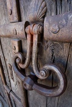 an old door handle on the wooden door