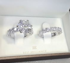 two engagement rings in a box on display