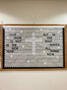 a bulletin board with words written on it and snowflakes all over the frame