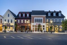 a row of buildings sitting on the side of a road