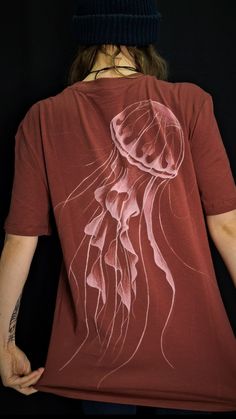 a person wearing a red t - shirt with a jellyfish on it's back