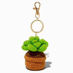 a crocheted potted plant keychain hanging from a metal hook