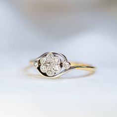 a diamond ring sitting on top of a white surface