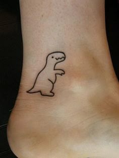 a small dinosaur tattoo on the ankle