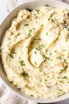 a bowl filled with mashed potatoes on top of a table