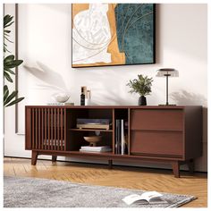 a living room with a book shelf next to a painting on the wall and a rug in front of it