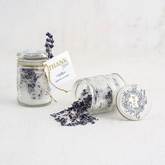 two jars filled with lavender flowers next to a small white tag that says thank you