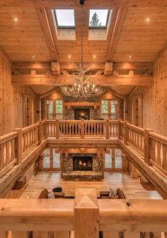 the inside of a large log cabin with chandelier