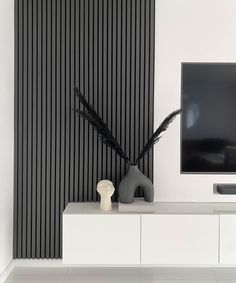 a flat screen tv sitting on top of a white entertainment center