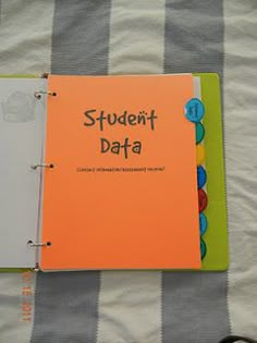 an open notebook sitting on top of a bed