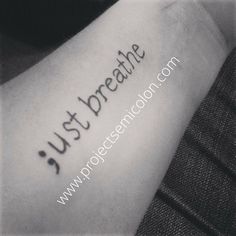 a person with a tattoo on their arm that says just breathe and it is written in cursive writing