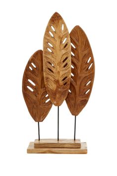 three wooden sculptures with metal stems and leaves on them, one is made out of wood